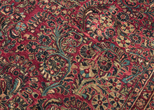 This rug features a curvilinear floral design on a red wine field. The floral work is intricate and an excellent example of the type of floral sprays Sarouk rugs are famed for. The main border features a palmette and blossom design on a navy ground. This classically patterned rug is perfect for high traffic areas and should last for generations to come. 