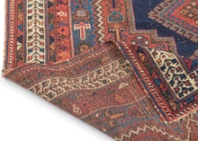 It features classic patterning associated with the Afshar people of Sirjan. In the center are two latch-hooked medallions on deep navy surrounded by a lacquer-red ground surrounded by a final field of cobalt.  Various greens, turqoise, apricot and aubergine contrast wonderfully and accentuate the various Small symbols and figures that fill the negative space. Nicely framed by an ivory main border which brightens the composition.