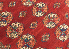 This Tekke main rug was handwoven during the first quarter of the 20th century in Turkmenistan.
The field features a grid rounded main guls in apricot, indigo, turqoise and ivory on vibrant red ground. The space between the grid is filled with rows of cruciform shaped secondary guls. In a rare square format that allows for very luxurious and open spacing of the guls.