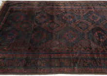 Timuri Baluch was handwoven during the second quarter of the 20th century in Western Afghanistan.
It features a lattice pattern of stepped diamonds and serrated polygons. With lush deep blue and red wool with a dark but lustrous complexion. The addition of a dark brown which has oxidized naturally sculpts the pattern and gives the shapes the feeling of floating in space. Bright speckles of white cotton have been woven around the main border adding a subtle touch of electricity. weft float