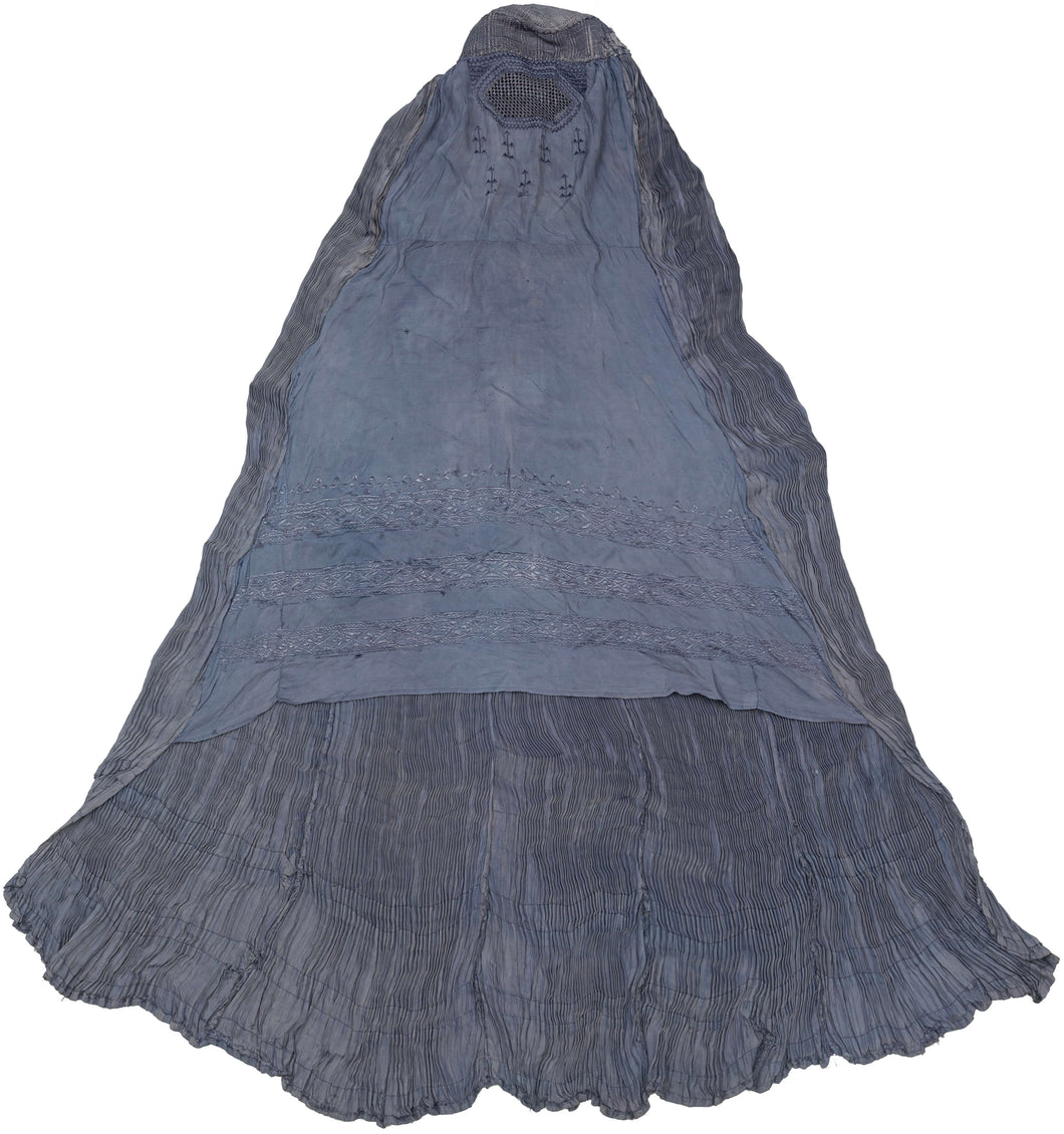 This Burqa was crafted in Afghanistan during the late 20th century. 
A burqa is a full-body garment that covers a woman's face and body. This burqa is made of periwinkle blue fabric with crimping around the back and floral embroidery below mesh opening for the eyes.
It is in good condition with small patches and some sun fading.
Special Provenance: Formerly in the collection of Yosi Barzilai Sarajo
