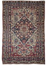 19th Century Lavar Kerman features a central medallion with a curvilinear floral design and scalloped cornices. The field is a rich raspberry color, nicely contrasted by the lighter pinks and creams of the cornices. The minor borders are composed of vine and leaf motifs, while the main border contains alternating blossoms in diamonds and cartouches.