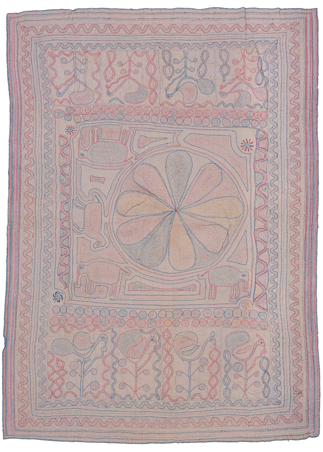 Bengali Kantha featuring an off-center mandala with reciprocal panels on top and bottom. The central mandala is squished to one side by three elephants and one horse form. The top and bottom panels both feature a row of plant forms that blossom into birds. Soft red, blue, and yellow on a soft pink ground.