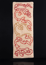 Handmade tufted rug with red, orange and yellow atop ivory ground. Curvilinear design spreads vertically transitioning from one color to the next.