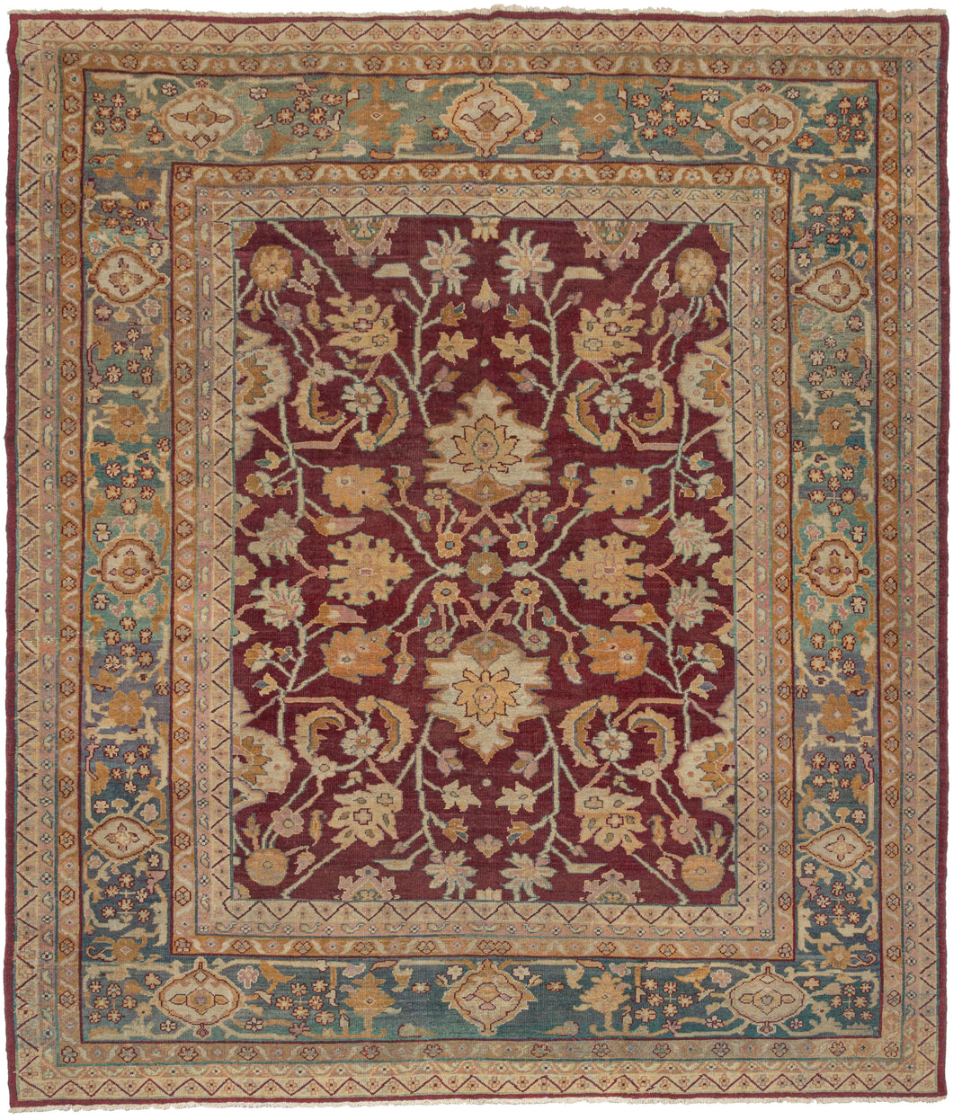Late 19th century Indian Amritsar rug featuring an elegant all-over design of palmettes, detailed blossoming vines, and groupings of curled leaves on a rich crimson ground. The crimson tone utilizes lac which is a dye derived from insects and characteristic of Northern India weaving from both Amritsar and Agra. With accents of gold, wheat, ivory, and pink. The whole is framed by a spectacular turquoise with a wonderful, undulating abrash that even has some moments of soft purple.