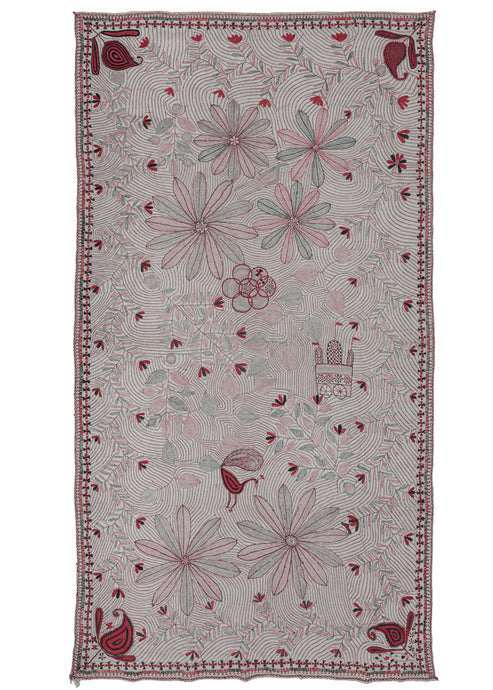 Antique large Bengali Kantha featuring a repeat field of flowering vines and curving lines as a backdrop to a small off-center mandala and large-scale floral forms. The addition of a peacock and a Vimana or flying palace adds some serious interest. The large-scale floral forms almost feel like fireworks exploding in the sky. The whole composition is flanked by richly rendered paisley or 