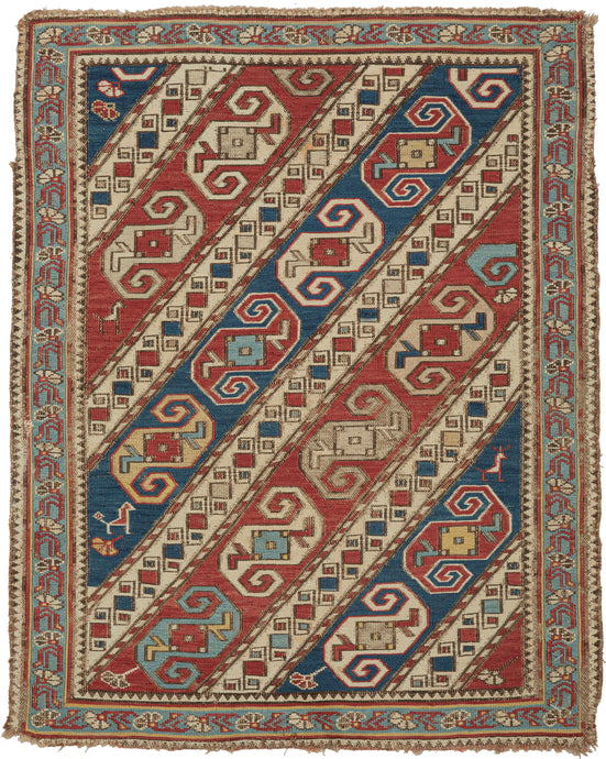 This finely woven Soumak was woven in the Kuba region of the eastern Caucasus during the late 19th century. 

The field is composed of dynamic diagonal bands filled with stylized zoomorphic and geometric motifs that are often interpreted as abstract dragons and set against alternating red, ivory, and blue grounds. These bands are interspersed with charming and symbolic filler elements like tiny birds and floral motifs that animate the composition with delightful irregularity.