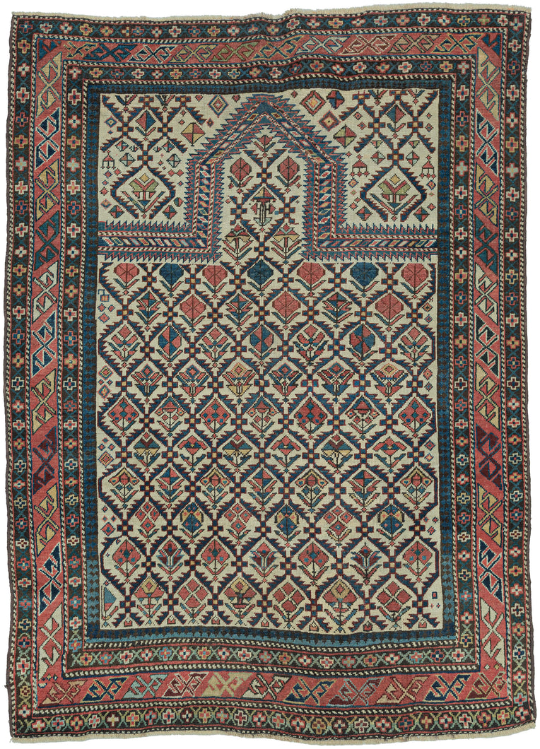 This finely woven late 19th-century Shirvan prayer rug exemplifies the sophisticated graphic language of the eastern Caucasus. Woven on a luminous ivory ground, the field is filled with an elegant lattice of stylized flowering plants and geometric blossoms, creating a rhythmic all-over pattern that is both highly ordered and remarkably lively.