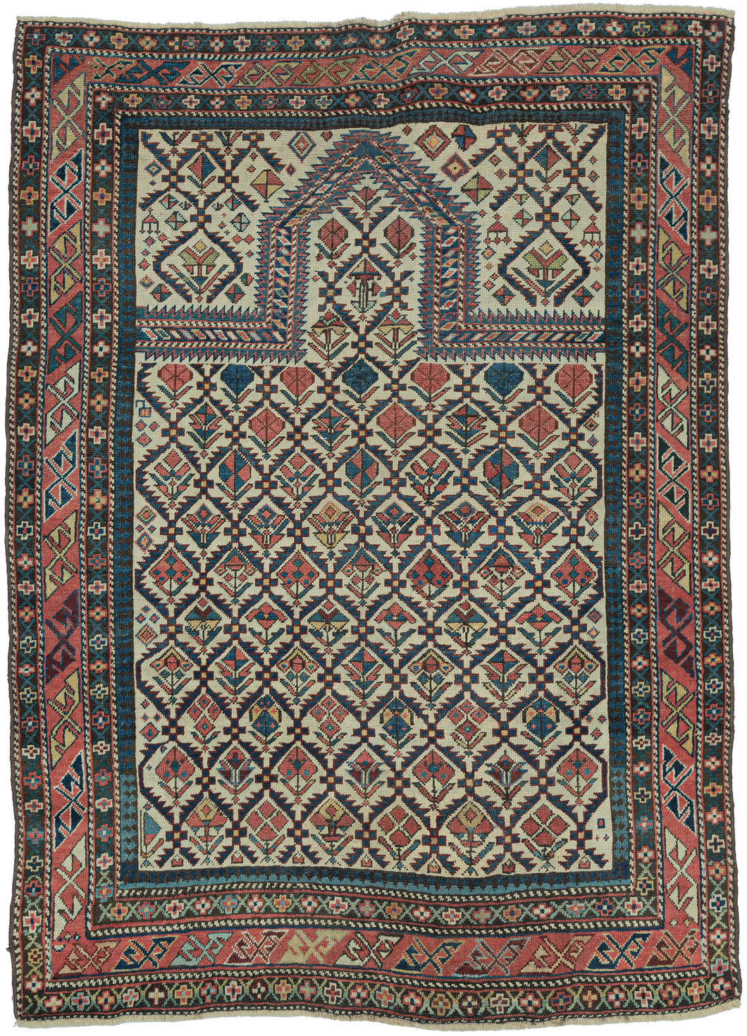 This finely woven late 19th-century Shirvan prayer rug exemplifies the sophisticated graphic language of the eastern Caucasus. Woven on a luminous ivory ground, the field is filled with an elegant lattice of stylized flowering plants and geometric blossoms, creating a rhythmic all-over pattern that is both highly ordered and remarkably lively.