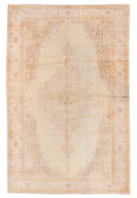 Woven of silk on a cotton foundation to sumptuous effect, this rug features a central medallion on an open field with four cornices. The ornate patterning is softened by the limited palette of yellow, cream and khaki with brown detailing. Soft tones and limited contrast make this a very easy rug to decorate around.