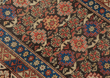A finely woven Chi-Chi rug from the northeastern Caucasus, packed with the dense, jewel-like drawing for which the group is prized. The dark chocolate-brown field is organized in horizontal bands of stepped geometric medallions alternating with tightly worked floral and abstract devices in saturated cobalt blue, brick red, ivory, soft green, and apricot.
