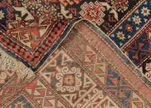 A finely woven Chi-Chi rug from the northeastern Caucasus, packed with the dense, jewel-like drawing for which the group is prized. The dark chocolate-brown field is organized in horizontal bands of stepped geometric medallions alternating with tightly worked floral and abstract devices in saturated cobalt blue, brick red, ivory, soft green, and apricot.