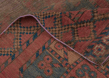 SILK KINTSUGI A soulful early Ersari Turkmen rug, measuring with a beautifully aged surface and a striking contemporary repair. The field is arranged with large-scale Turkmen guls in a soft, time-muted palette of deep red, brown, indigo, charcoal, and ivory. Years of wear have softened the design, giving the rug a quiet, atmospheric quality while still preserving the rhythm and strength of its original tribal composition.