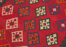 Diagonal diamonds on a powerful undulating red ground. The field is surrounded by a wide inner border with thinner diamonds on the sides and alternating triangles on the ends against a desirable and enchanting green ground. The whole is framed by a tightly rendered but somewhat erratic laleh abbasi border and finished with puzzle piece banded skirt borders. The edges are finished with candy cane selvedges in orange and blue with the occasionally poof of yarn Qashqai