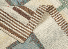 This Röllakan kilim was handwoven in Sweden during the middle of the 20th century.

It features a symmetrical layout with soft pastel shades of blue, pink, yellow, and green against an ethereal backdrop. The structured pattern of repeating squares and circles and the totemic green columns create a sense of rhythm and harmony. The background is composed of various marled yarns in ivory, yellow and a grayish green that provide wonderful depth and make the other elements appear to float above it.