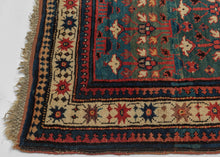 This rug was woven in the South Caucasus in or around the Karabagh region and is dated as 1281 Hijri or 1864 in the Gregorian calendar.&nbsp;

It features a rare and poetic allover design of stylized floral shrubs ngrowing from pots and evoking themes of paradise gardens. The uncommon and desirable rich green ground shifts in tone from hunter green to forest green and finally a sublime sapphire blue. The overall rhythm is visually arresting—layered yet orderly, with fine asymmetrical details that animate th