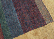 A refined example of modern Gabbeh weaving, this piece offers a minimalist meditation on color and form. Bands of saturated burgundy, indigo, and green move across a central panel, grounded by a glowing yellow field that frames the composition with quiet elegance.

Gabbeh rugs are known for their thick wool, subtle variegation, and expressive use of natural dyes. This example distills those elements into a bold yet harmonious design that is both rooted in tradition and strikingly modern.