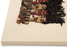 This Pre-Columbian textile fragment dates to the Wari period (circa 600–1000 AD).

It features a striking row of anthropomorphic head motifs with dramatic black wool tufts, likely once serving as the decorative fringe of an elite garment or ceremonial textile. The figures, worked in shades of cochineal red, green, gold, and deep indigo, are a hallmark of Wari iconography and exhibit the sophisticated interlinking knit structure that this Andean culture pioneered.

The fragment remains in very good condition