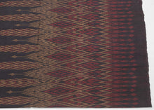 This elegant silk pha sin or traditional tube skirt was handmade northeast Thailand during the middle of the 20th century.

It is a masterful example of mudmee (ikat) weaving from the Isaan region.&nbsp;The central field (phuen sinh) displays alternating vertical bands of nested diamonds and stylized rice ear or flame motifs that are elongated and tapered into arrow forms that symbolize fertility, protection, and spiritual aspiration in regional Lao-Tai iconography.

The top band (hua sinh) offers a rhythm 