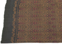 This elegant silk pha sin or traditional tube skirt was handmade northeast Thailand during the middle of the 20th century.

It is a masterful example of mudmee (ikat) weaving from the Isaan region. Woven entirely from fine silk, the textile features a mesmerizing field of diamond motifs arranged in vertical zigzag bands, subtly interlaced with red, gold, and deep aubergine tones against a near-black ground. The effect is one of shimmering depth and rhythmic precision.

The upper and lower bands (hua sinh an