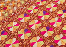 Phulkari is a traditional folk embroidery style from the Punjab region, which spans both India and Pakistan. It is composed of colorful silken thread atop rough cotton cloth.&nbsp;This Phulkari was embroidered in silk floss on multiple red cotton strips and features a striking composition of kaleidoscopic floral medallions arranged in a dense grid. Finished with skirt borders of interlocking motifs, including zoomorphic bird-like figures on one end.&nbsp; Highly contrasting tones of fuchsia, saffron, pistac