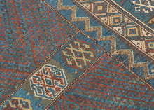 This rug was likely woven likely in the Hakkari - Rawanduz corridor of the Kurdish Highlands of Iraq during the turn of the 20th century

This deeply expressive Kurdish village rug presents a masterclass in tribal geometry, color harmony, and cultural symbolism. It features a field anchored by two nested diamond medallions, each filled with small, rhythmic glyph-like motifs and set against a ground of saturated indigo blue and madder red abrashed into glowing mineral shades. Surrounding the central field ar