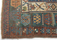 This rug was likely woven likely in the Hakkari - Rawanduz corridor of the Kurdish Highlands of Iraq during the turn of the 20th century

This deeply expressive Kurdish village rug presents a masterclass in tribal geometry, color harmony, and cultural symbolism. It features a field anchored by two nested diamond medallions, each filled with small, rhythmic glyph-like motifs and set against a ground of saturated indigo blue and madder red abrashed into glowing mineral shades. Surrounding the central field ar