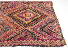It features a bold diamond design in a striking palette of magenta, orange, black and ivory, accented with intricate lattice and geometric motifs. The vibrant colors and dynamic patterning reflect the artistic spirit of the Zemmour weaving tradition. In a very rare large squarish size.&nbsp;Perfect for adding energy and warmth to any space.&nbsp; A very free-spirited weaving.