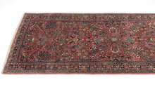 This rug showcases a classic curvilinear floral design on a deep red field beautifully detailed with scrolling vines, palmettes, and blossoming sprays. This classically patterned rug is perfect for high traffic areas and should last for generations to come. It's rare short runner size makes it perfect for an entryway, kitchen or as a statement piece in a more intimate space.