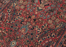 This rug showcases a classic curvilinear floral design on a deep red field beautifully detailed with scrolling vines, palmettes, and blossoming sprays. This classically patterned rug is perfect for high traffic areas and should last for generations to come. It's rare short runner size makes it perfect for an entryway, kitchen or as a statement piece in a more intimate space.
