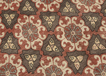 It features a striking allover lattice design with repeating floral rosettes and angular motifs in a balanced palette of earthy terracotta, chocolate brown, ivory, and soft blue. The wide border, decorated with stylized stars and angular vine elements, frames the field beautifully, adding depth and structure to the pattern. The bold yet harmonious composition and soft tones exemplify the sophisticated village weaving traditions of the region.