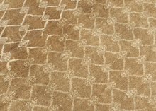 KURD Its warm camel field is animated by a playfully wonky interlocking lattice and framed by a border of larger floral medallions in soft ivory and beige. The lattice has the feel of a bent and distorted chain link fence. The delightful irregularity in the design has an endearing quality that speaks to its handmade nature and gives the piece a unique, almost whimsical character. The washed out neutral palette and subtle abrash create a natural warmth, making it a versatile choice for both traditional and c