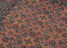 This Sparta rug was handwoven during the middle of the 20th century in Western Anatolia.

It showcases an all over Herati design floral lattice with playful rosettes and curling vinery set against a fun watermelon ground. The rest of the palette blends soft blues, mossy greens and golden accents to create a midcentury vibe.&nbsp;