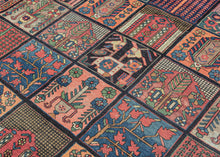 A dazzling mosaic of color and pattern, this Bakhtiari garden carpet embodies one of the most celebrated designs in Bakhtiari weaving. The field is laid out in a grid of rectangular compartments, each filled with distinctive vignettes of stylized floral sprays, trees of life, geometric abstractions, and architectural motifs. The diversity within each panel creates a captivating patchwork, at once orderly and exuberant. Lively tones of coral, madder red, indigo, sky blue, ivory, and soft green animate the de