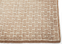 A strikingly modern design from Eastern Anatolia, this Kars rug features a minimalist “brick” pattern rendered in soft tones of cream and sandy beige. The repeating geometric motif creates a rhythmic grid across the field, at once architectural and understated. It is an aesthetic that feels remarkably contemporary despite its traditional handwoven origins.