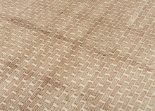 A strikingly modern design from Eastern Anatolia, this Kars rug features a minimalist “brick” pattern rendered in soft tones of cream and sandy beige. The repeating geometric motif creates a rhythmic grid across the field, at once architectural and understated. It is an aesthetic that feels remarkably contemporary despite its traditional handwoven origins.