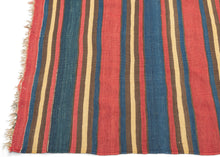 A striking example of simplicity elevated to art, this antique Shahsavan kilim reveals the timeless sophistication of stripe-based design. Its alternating bands of madder red, indigo blue, golden ochre, and earthy brown create a bold yet harmonious rhythm across the surface. The restrained palette and unbroken horizontality give the piece a modernist clarity that feels as relevant today as it did over a century ago.