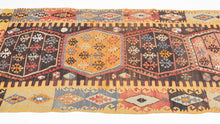 This kilim was handwoven in the Malatalya region of Eastern Anatolian during the early 20th century.

It features a horizontal row of four multi-lobed medallions, each filled with stylized floral motifs. The medallions float on a deep walnut-brown ground, offset by aubergine, apricot, saffron yellow, indigo, soft blues, and madder tones. The surrounding borders alternate hooked amulet forms and diamond devices, creating a rhythmic frame around the central axis.