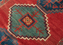 This Kazak rug was handwoven in the Southwest Caucasus during the early 20th century.

A striking example featuring three boldly drawn stepped medallions set against a vibrant, glowing red field. The palette is classic Southwest Caucasian: deep indigo, moss green, ivory, and saturated natural reds that radiate warmth and energy. The central medallion really pops and is distinguished by a lovely jewel toned blue green and enhanced by a starkly contrasting ivory outline that giving the piece strong graphic pr
