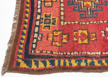 This Kurdish Yatak was handwoven in Eastern Anatolia during the late 19th century.

A vibrant and expressive Kurdish Anatolian Yatak, woven in the highland villages of Eastern Anatolia and originally intended as a sleeping or bedding rug. The format is classic with a warm, saturated red field filled with a rhythmic repeat of memling guls outlined in deep indigo and enlivened with saffron, ivory, moss green, and brick tones. The drawing is bold and spontaneous, full of angular hooked outlines and charming tr