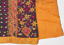 This vibrant ceremonial sari exemplifies the Rabari embroidery tradition of Gujarat. Worked on a lustrous silk ground, the field is covered in hand-embroidered satin-stitch dots in jewel tones of magenta, saffron, and ivory, echoing the region’s famed bandhani aesthetic. The richly decorated end panel features dense floral and geometric embroidery in silk floss threads, highlighted with mirror insets, symbolic of protection and celebration within Rabari culture. Such pieces were created as dowry or ceremoni