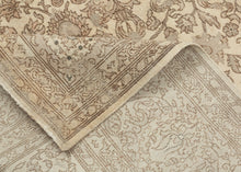 A softly washed-out mid-century Sivas rug handwoven in central Anatolia, featuring an even, atmospheric palette and a finely detailed floral field. The original drawing remains legible yet subdued, creating a gentle, almost parchment-like surface where pattern and ground merge into a cohesive whole. Subtle animal figures are interwoven within the scrolling arabesques, revealing themselves gradually and rewarding closer looking.