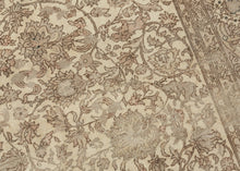 A softly washed-out mid-century Sivas rug handwoven in central Anatolia, featuring an even, atmospheric palette and a finely detailed floral field. The original drawing remains legible yet subdued, creating a gentle, almost parchment-like surface where pattern and ground merge into a cohesive whole. Subtle animal figures are interwoven within the scrolling arabesques, revealing themselves gradually and rewarding closer looking.