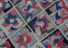 Buyi quilt cover with gridded cotton panels featuring abstract floral, yin-yang, and butterfly motifs in blues, reds, and patterned fabrics, with visible hand stitching and wear.