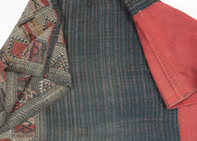 A finely woven woman’s skirt associated with Tai-speaking communities of northern Laos and northwestern Vietnam.

The textile is constructed in three distinct sections with a red cotton waistband, a dark indigo body enlivened with subtle horizontal striping, and an intricately patterned lower panel. The restrained palette of indigo, cream, ochre and red gives the skirt an unusually graphic quality.