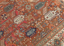 This exceptional late 19th-century Shekarlu rug is a superb example of the bold, highly expressive weaving tradition of the Qashqai Confederacy. Its rich terracotta field is animated by an elegant arrangement of towering cypress and tree-of-life motifs, interspersed with a lively assortment of tribal devices, rosettes, birds, combs, and other protective talismanic symbols that reward close inspection.