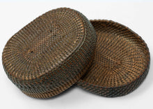 A finely made lidded basket attributed to the Kuba peoples of the Democratic Republic of the Congo, tightly plaited from plant fiber into a compact, low rounded form.

The weaving radiates outward from the center in subtly shifting directions, creating a quiet sense of movement across the otherwise unadorned surface. The closely fitted lid and shallow base reflect the technical precision for which Kuba basketry is known.