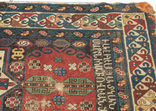 An extraordinary Armenian inscribed rug dated 1894, with a powerful sequence of geometric medallions set against a richly colored field of red, ivory, green, blue, yellow, and aubergine. The drawing is wonderfully individual, with bold hooked forms, small floral devices, and a lively multicolored border framing the composition.

Most compelling is the woven Armenian inscription, which appears to read:

“The rug of Satenik Abovian, in the year 1894.”