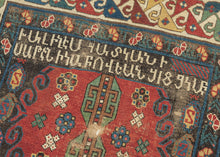 An extraordinary Armenian inscribed rug dated 1894, with a powerful sequence of geometric medallions set against a richly colored field of red, ivory, green, blue, yellow, and aubergine. The drawing is wonderfully individual, with bold hooked forms, small floral devices, and a lively multicolored border framing the composition.

Most compelling is the woven Armenian inscription, which appears to read:

“The rug of Satenik Abovian, in the year 1894.”