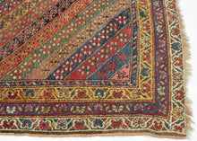 An exceptional Kurdish rug distinguished above all by its top-notch color and superb wool. The field is composed of lively diagonal bands, each carrying a different floral or geometric repeat and shifting through saturated brick red, deep indigo, grassy green, ivory, ochre, aubergine, and soft rose.